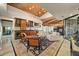 Living room with beamed ceilings, full bar, and sliding glass doors at 6432 E El Sendero Rd, Carefree, AZ 85377