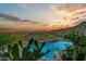 Beautiful pool with sunset views, surrounded by desert landscape and lush greenery at 6432 E El Sendero Rd, Carefree, AZ 85377