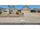 Cozy single level home with desert landscaping, two-car garage, and gated front yard at 6804 W Turquoise Ave, Peoria, AZ 85345