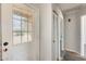 Entryway featuring a white door with window, closet and access to adjacent rooms at 6804 W Turquoise Ave, Peoria, AZ 85345