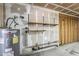 Unfinished utility room featuring a Rheem water heater and shelving at 6804 W Turquoise Ave, Peoria, AZ 85345