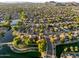Stunning aerial view of lakeside community features lush landscaping and a beautiful lake at 6907 W Monona Dr, Glendale, AZ 85308