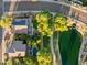 Stunning aerial view of the home showcasing a solar panel system, a community lake, and mature landscaping at 6907 W Monona Dr, Glendale, AZ 85308