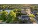 Aerial view of a community with solar panels and lake views highlighting lush greenery and attractive homes at 6907 W Monona Dr, Glendale, AZ 85308
