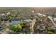 Panoramic aerial view of a community with lakes and homes, showcasing mature trees and residential streets at 6907 W Monona Dr, Glendale, AZ 85308