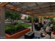 Inviting outdoor patio with pergola, comfortable seating, a fire pit, and a lush backyard view at sunset at 6907 W Monona Dr, Glendale, AZ 85308