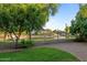 Landscaped backyard features a pond view and wrought iron fence at 6907 W Monona Dr, Glendale, AZ 85308