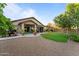 Expansive backyard features lush lawn, mature trees, an outdoor grill, and covered patio perfect for entertaining at 6907 W Monona Dr, Glendale, AZ 85308