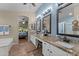 Bathroom with dual sinks, granite countertops, and decorative mirrors at 6907 W Monona Dr, Glendale, AZ 85308