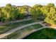 Scenic view of a home near a community pond, with walking paths and lush landscaping creating a peaceful setting at 6907 W Monona Dr, Glendale, AZ 85308