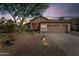 Charming single-story home boasts a desert landscape, brick walkway, and a two-car garage in a quiet neighborhood at 6907 W Monona Dr, Glendale, AZ 85308
