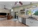 Well-lit kitchen flowing into the living area with stainless appliances at 6907 W Monona Dr, Glendale, AZ 85308