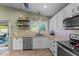 Kitchen features stainless steel appliances, a window view, and custom cabinetry at 6907 W Monona Dr, Glendale, AZ 85308