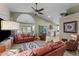 Open-concept living area with vaulted ceiling, leather sofas, and access to the kitchen at 6907 W Monona Dr, Glendale, AZ 85308