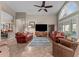 Bright and airy living room with leather sofas, ceiling fan, and large windows at 6907 W Monona Dr, Glendale, AZ 85308