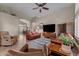 Open-plan living space with multiple leather sofas and connecting dining area at 6907 W Monona Dr, Glendale, AZ 85308