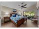 Comfortable primary bedroom with a ceiling fan, wood floors, and patio access at 6907 W Monona Dr, Glendale, AZ 85308