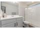 Bright bathroom featuring a double sink vanity and glass-enclosed shower at 7123 W Andrea Dr, Peoria, AZ 85383