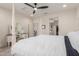 Spacious bedroom featuring a luxurious four-poster bed, vanity, and access to the ensuite bathroom at 7123 W Andrea Dr, Peoria, AZ 85383
