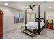 Bedroom featuring a four-poster bed, modern ceiling fan and window with blinds at 7123 W Andrea Dr, Peoria, AZ 85383