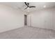 Large bedroom with neutral carpeting and open doorway to hallway at 7123 W Andrea Dr, Peoria, AZ 85383