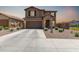 Two-story home showcasing stone accents, a two-car garage, and low-maintenance desert landscaping at 7123 W Andrea Dr, Peoria, AZ 85383