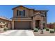 Charming two-story home with stone accents, a two-car garage, desert landscaping, and covered front entryway at 7123 W Andrea Dr, Peoria, AZ 85383