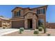 Two-story home with stone accents, a two-car garage, and xeriscaped front yard at 7123 W Andrea Dr, Peoria, AZ 85383