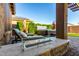 Relaxing backyard with modern gas fire feature and hot tub on the covered patio, great for outdoor enjoyment at 7123 W Andrea Dr, Peoria, AZ 85383