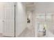 Hallway leading to bedrooms and stairs with neutral carpeting and white walls at 7123 W Andrea Dr, Peoria, AZ 85383