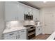 Close-up of a kitchen with stainless steel appliances, quartz countertops, and tile backsplash at 7123 W Andrea Dr, Peoria, AZ 85383