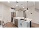 Kitchen featuring a spacious island, stainless steel appliances, and modern lighting at 7123 W Andrea Dr, Peoria, AZ 85383