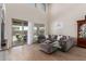 Bright living room featuring neutral tones, a comfortable sectional sofa, and access to the outdoor patio at 7123 W Andrea Dr, Peoria, AZ 85383