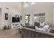 Spacious living room with high ceilings, a large sectional, and a backyard view at 7123 W Andrea Dr, Peoria, AZ 85383
