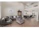 Open-concept living room featuring modern furnishings, adjacent to the kitchen, and a stylish dining area at 7123 W Andrea Dr, Peoria, AZ 85383