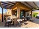Relaxing covered patio boasts a built-in BBQ, bar seating, and outdoor furniture, great for outdoor gatherings at 7123 W Andrea Dr, Peoria, AZ 85383