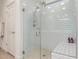 Modern shower with white subway tile, a glass enclosure, and a built-in bench at 7123 W Andrea Dr, Peoria, AZ 85383