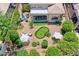 Aerial view of backyard featuring a manicured lawn, putting green, seating areas, and lush landscaping at 7128 E Bramble Berry Ln, Scottsdale, AZ 85266