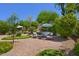 Gorgeous backyard with a putting green, lush landscaping, and comfortable seating areas under shade at 7128 E Bramble Berry Ln, Scottsdale, AZ 85266