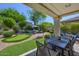 Entertaining backyard showcases a putting green, mature landscaping, and an inviting outdoor dining space at 7128 E Bramble Berry Ln, Scottsdale, AZ 85266