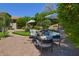 Beautiful backyard featuring a brick patio, lush landscaping, and comfortable seating areas at 7128 E Bramble Berry Ln, Scottsdale, AZ 85266