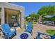 Entertain friends and Gathering in the landscaped backyard featuring a fire pit and comfortable lounge seating at 7128 E Bramble Berry Ln, Scottsdale, AZ 85266