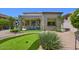 Landscaped backyard featuring a putting green, patio area, and outdoor entertainment spaces at 7128 E Bramble Berry Ln, Scottsdale, AZ 85266