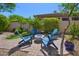 Relaxing backyard featuring a fire pit and comfortable Adirondack chairs, perfect for outdoor gathering at 7128 E Bramble Berry Ln, Scottsdale, AZ 85266
