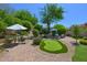 Stunning backyard featuring a putting green, landscaped grounds, and comfortable seating areas at 7128 E Bramble Berry Ln, Scottsdale, AZ 85266
