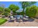 Serene backyard featuring a seating area, lush landscaping, and a well-manicured lawn at 7128 E Bramble Berry Ln, Scottsdale, AZ 85266