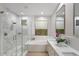Bright bathroom features double sinks, a soaking tub, and a glass enclosed shower with designer tile at 7128 E Bramble Berry Ln, Scottsdale, AZ 85266