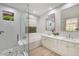 Bright bathroom featuring dual sinks, separate shower, soaking tub, and backyard window at 7128 E Bramble Berry Ln, Scottsdale, AZ 85266