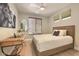 Cozy bedroom offers neutral tones, a ceiling fan, and ample natural light for a comfortable retreat at 7128 E Bramble Berry Ln, Scottsdale, AZ 85266