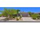 Charming single-story home with a desert landscaped front yard and attached two car garage at 7128 E Bramble Berry Ln, Scottsdale, AZ 85266
